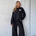 Ensemble détente noir pour femmes avec sweat à imprimé cœur et pantalon de jogging large - S / Noir
