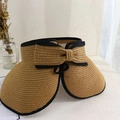 Close-up of a khaki straw sun hat featuring a large bow and black contrast edge - Khaki