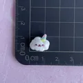 Close-up of a mini resin unicorn cloud accessory with a ruler showing the 1.5cm size - Smiling Cloud with Hat