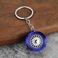 Detail of multi-spoke car wheel keychain with blue plating and silver spokes on wood - Blue + White K