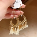 Detail of vintage gold feather earrings with beige tassels and hollow metal leaf pendants - Hollow Metal Beige Tassel Style (7#)