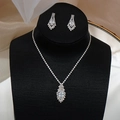 Macro shot of silver bridal necklace and marquise zircon drop earrings on a black neck model - GS010 Marquise Halo Set / Silver