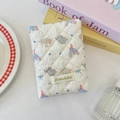 Close-up of quilted ivory fabric featuring a cute cartoon elephant and bow tie pattern - Bowknot Elephant