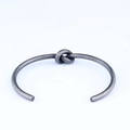Retro stainless steel open cuff bracelet featuring a unique vintage wire knot design - Steel