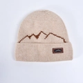 Winter knit beanie in beige with brown mountain pattern and leather logo patch - Beige