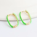 Close-up of golden oval hoop earrings with vibrant green enamel and hinged closures - Green