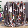 Detail of Christmas flannel blanket with snowman and tree print on a cozy sofa - MT02-09 (Grey Christmas Mix)