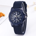 Close-up of a blue military quartz watch with canvas strap and luminous Arabic numerals - Blue