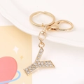 Detail of a golden letter Y keychain pendant encrusted with sparkling white rhinestones - Letter Y