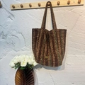 Brown and green striped tweed tote bag with a golden handmade metal logo hanging on a hook - Brown and Green Stripes