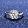 Macro shot of S925 sterling silver ring showing halo-set brilliant-cut zircon on blue background - Adjustable / Style 11 Halo Ring (1 Carat)
