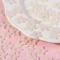 Macro detail of white hollow star-shaped faux pearl beads for DIY craft decoration - Off White