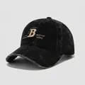 Close-up of vintage black corduroy fabric with gold 3D embroidery on a kids baseball cap - 54cm (3-8 Years) / Black