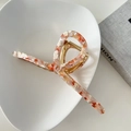 Detail of 13cm oversized marble orange acetate hair claw clip on minimalist ceramic tray - Sakura Pink