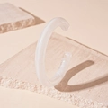 Detailed view of white translucent acrylic cuff bracelet on a minimalist stone base - White