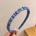 Detailed view of the pleated blue satin fabric texture on this stylish hairband - Pleated Satin Style / Blue