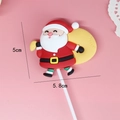Detail view of a 5.8x5cm Santa Claus silicone cake topper decoration for holiday baking - Santa with Yellow Bag