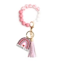 Dettaglio portachiavi a bracciale con perle rosa, pendente arcobaleno e nappa in pelle - Stampa Mucca Nappina Rosa