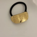 Minimalist elastic hair tie with textured gold metal plate and cracked pattern finish - Large Oval Checkered Pattern Gold