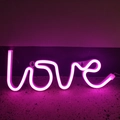 Stylized pink LED neon sign spelling love in a script font for romantic party decor - Battery and USB Dual Use / Pink