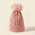 Pink winter knit beanie featuring thick cable patterns and a large fluffy pom-pom detail - Pink