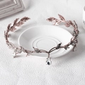 Detail of rose gold leaf bridal tiara with sparkling crystals and drop pendant - Pink with White Gemstone