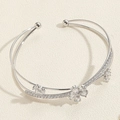 Macro shot of silver dual-line open bangle with three zircon flowers and crystal pavé details - SL0184-1 Flower Bangle