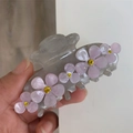 Detailed close-up of translucent gray hair claw clip with pink floral rhinestone inlay - Grey Purple Flower