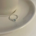 Silver twisted ring with a round light blue gemstone in an adjustable open band design - Blue Gemstone Twisted Style (J3759)
