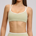 Light olive green sports bra with white trim and slim shoulder straps for fitness - S / Tops / Midsummer Green