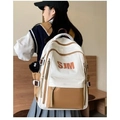 Side view of American vintage white and brown backpack worn by a model in a room - Brown Without Pendant