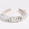 Close-up of luxury padded headband featuring white faux pearls and clear crystals - White