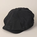 Close-up of black washed cotton newsboy cap showing stitched panels and top button - Black