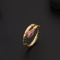 Macro detail of gold-plated snake ring featuring red crystal eyes and scale texture - Ruby Color Snake Head and Tail Style