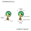 Detail of Christmas earrings featuring green bead and gold tree pendant with zircons - Green Bead Christmas Tree Earrings