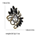 Vintage grey teardrop crystal brooch with black leaf accents and gold metal finish - Black