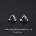Sterling silver Aries zodiac stud earrings with sparkling cubic zirconia on black sand - Aries