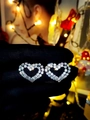 Double-layered sparkling heart earrings with clear crystals held in hand - Silver Double Layer Heart (DTE1216277S)