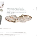 Bow-shaped metal hair clip with amber rhinestones and crystals in macro view - Forest Flower Champagne