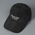 Close-up of black nylon baseball cap with white 'Dreams Come True' embroidery detail - M (56-58cm) / Black