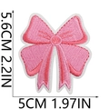 Pink embroidered bow patch showing detailed dimensions in centimeters and inches - US 13