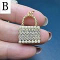 Macro shot of a gold-plated handbag-shaped pendant with rows of cubic zirconia and pearls - Style B-Handbag