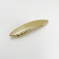 Detail of a golden oval metal hair clip with fine texture and premium punk style finish - Long Oval Gold