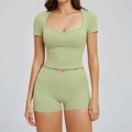 Two-piece avocado green yoga set featuring heart-neck top and crossover waist shorts - S / Bean Green
