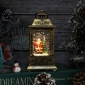 Nahaufnahme der goldenen Weihnachts-Laterne mit Weihnachtsmann und Glitzereffekt - Weihnachtsmann