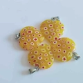 Yellow heart pendants with red and white floral patterns and silver metal clasps - Yellow Millefiori Glass