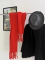 Maillard style long red fringe knit scarf displayed with a grey hat and black faux fur coat - Solid Red
