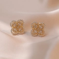 Golden clover stud earrings with sparkling cubic zirconia insets on silk background - Gold Four-Leaf Clover Micro-Pave Style (E0519)