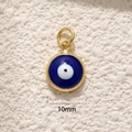 Macro detail of a 10mm round gold-plated evil eye pendant with blue and white enamel inlay - 10mm Gold Blue Eye