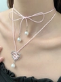 Close-up of pink silk ribbon choker with silver thorn heart pendant and white pearls - Pink Ribbon Lace-up Barbed Heart Choker (N-234)